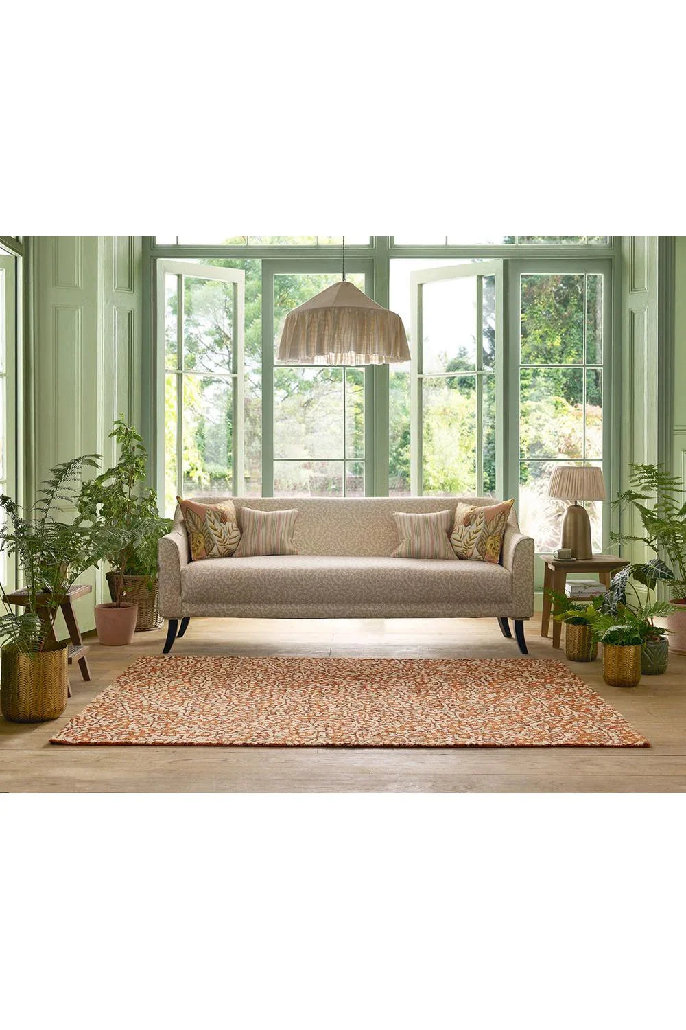 Sanderson Truffle Sandstone Outdoor Rug featuring ornate lattice pattern in sandstone orange, cream and taupe on beige background, machine-woven polypropylene