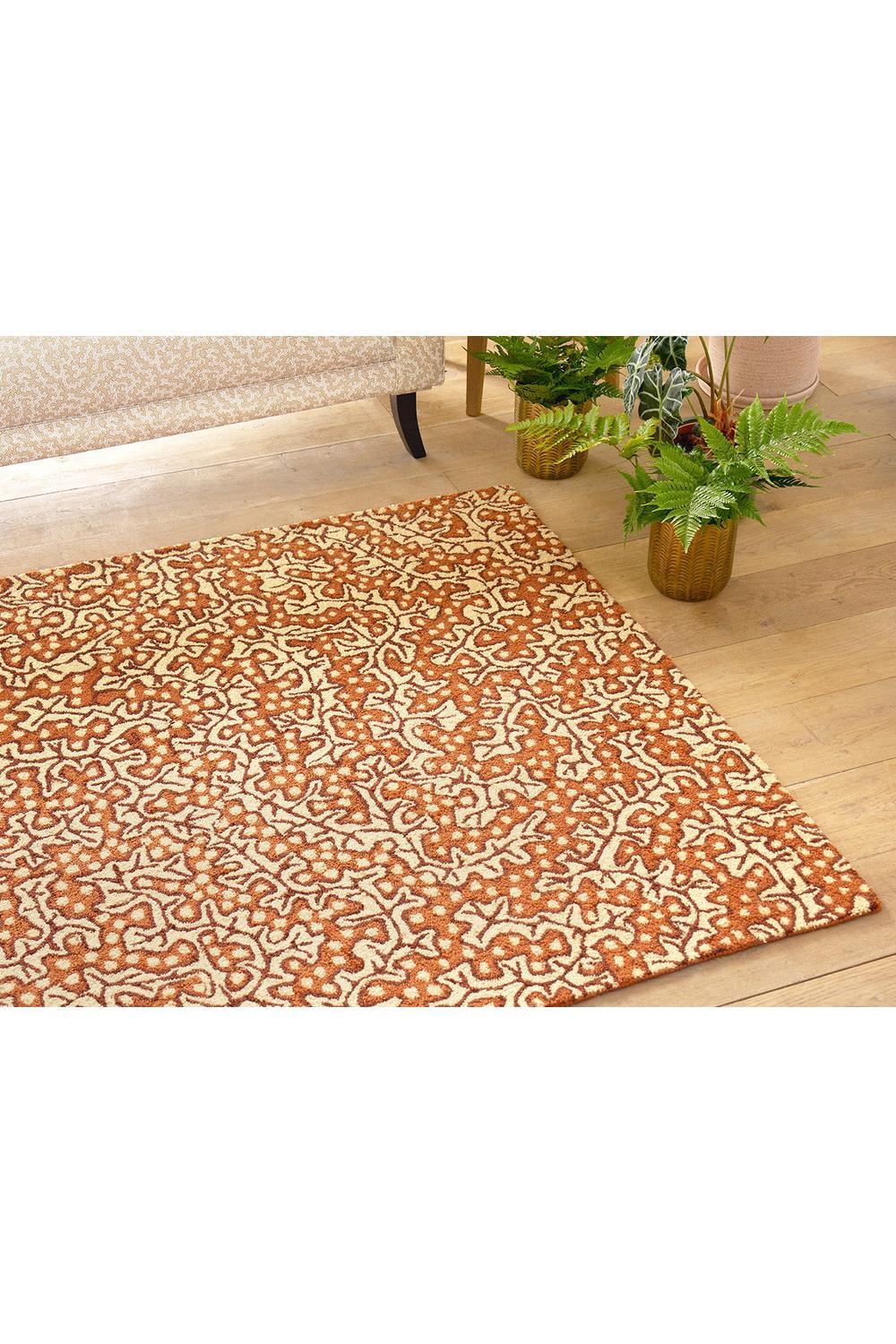 Sanderson Truffle Sandstone Designer Outdoor Rug featuring abstract pattern in burnt orange and cream on warm cream background, machine-woven polypropylene