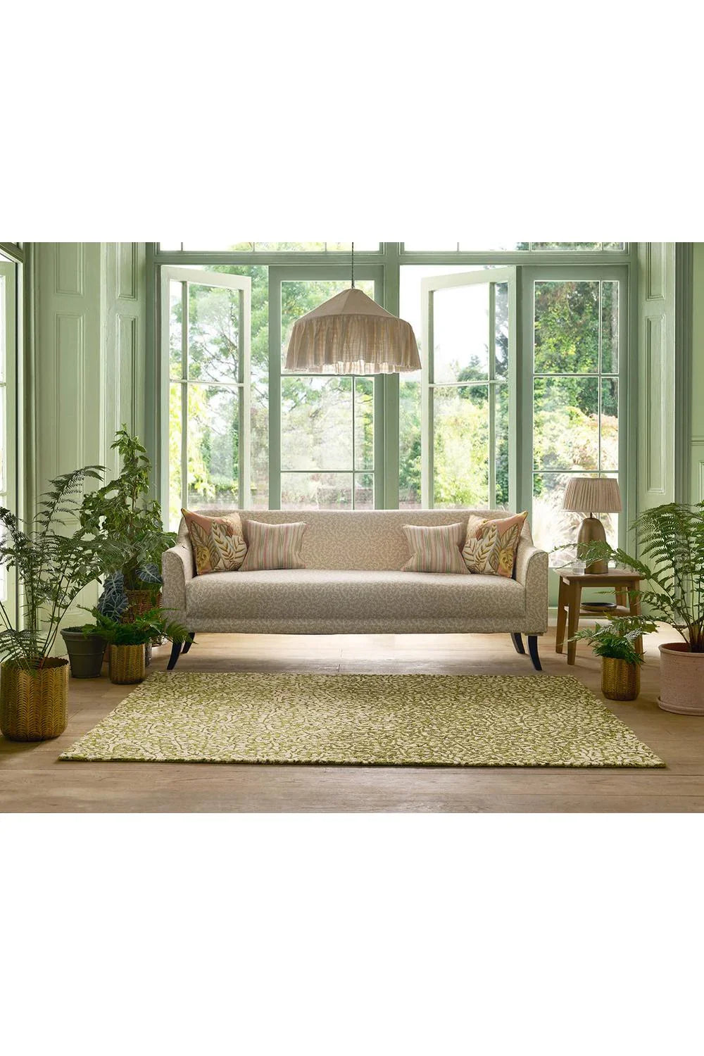 Sanderson Truffle Olive Designer Outdoor Rug featuring botanical pattern in olive, sage-green and cream on pale beige background, power-loomed polypropylene