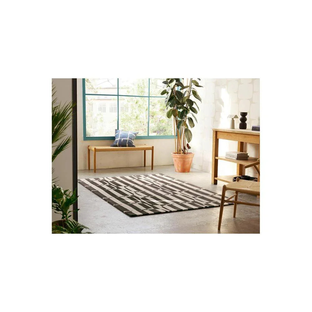 Scion Lohko Stripe-charcoal Designer Rug featuring geometric stripe pattern in charcoal and white on beige background, hand-tufted wool