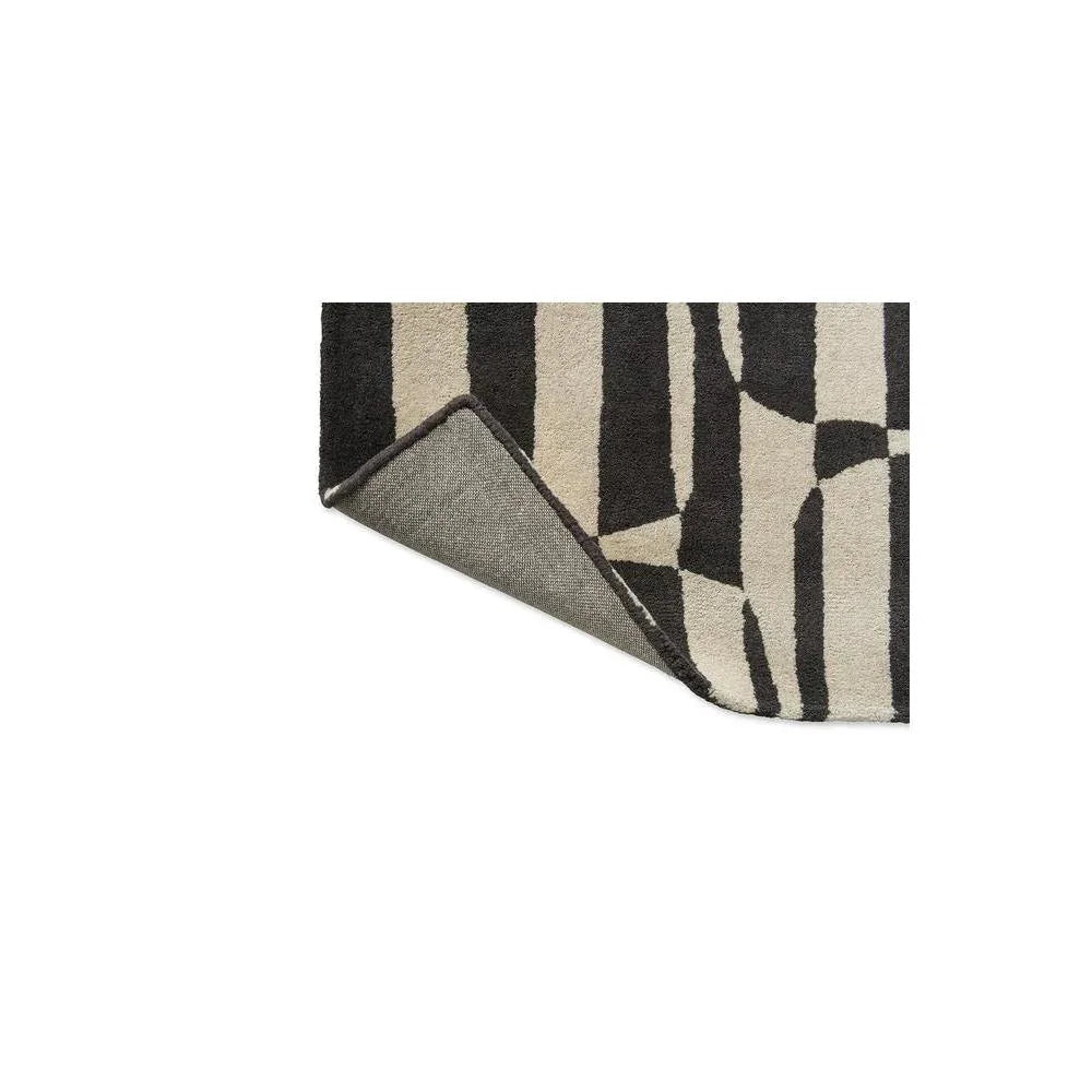 Scion Lohko Stripe-charcoal rug featuring bold geometric stripes in charcoal, cream and black on ivory background, hand-tufted wool