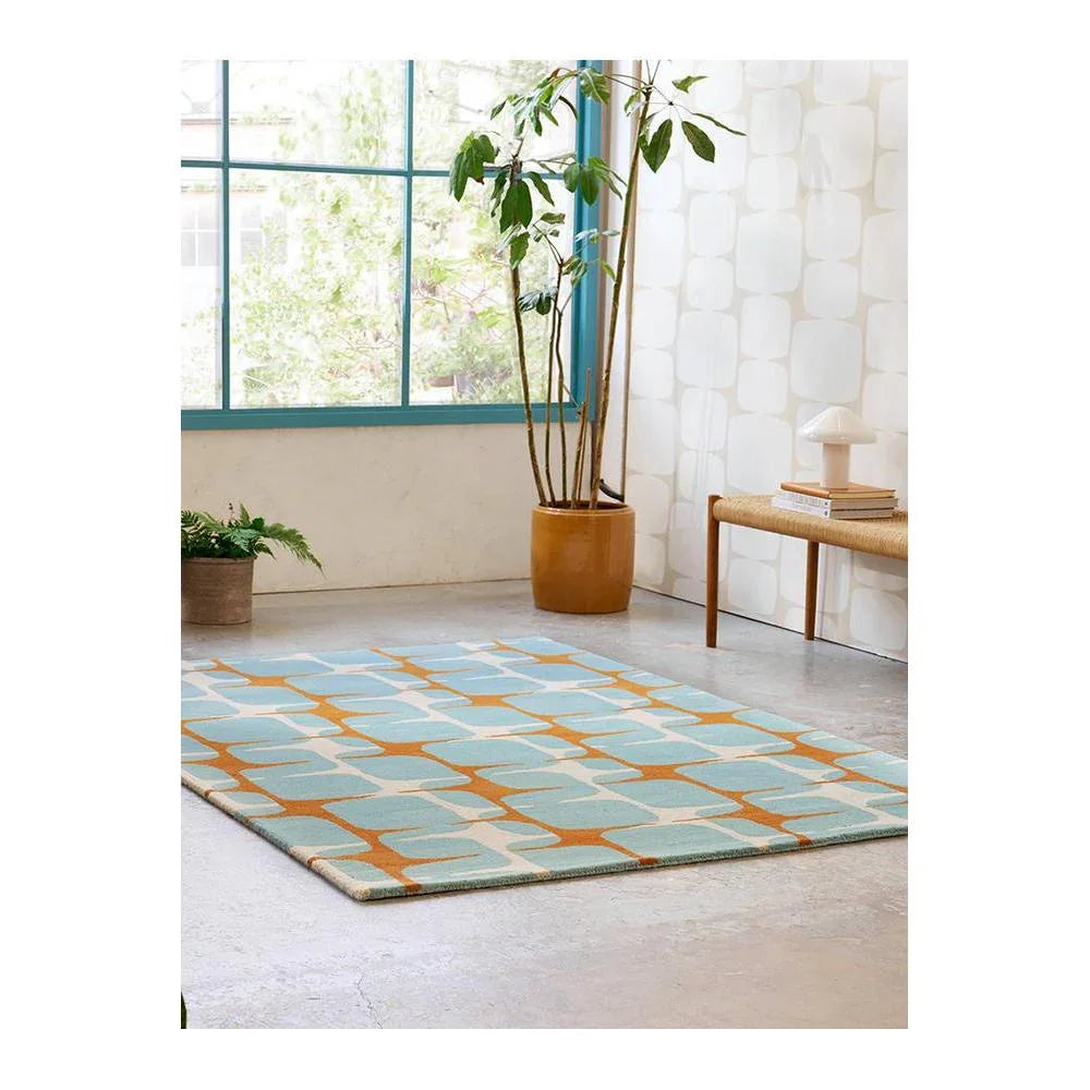 Scion Going Lohko - Sky Designer Rug featuring geometric lattice pattern in teal, sky blue, orange on cream background, hand-tufted wool