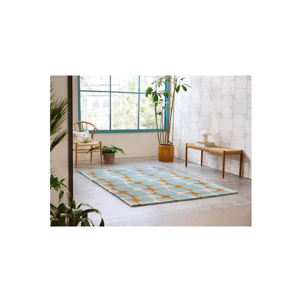 Scion Going Lohko Sky Designer Rug featuring geometric lattice in teal, sky blue and orange on cream background, hand-tufted wool