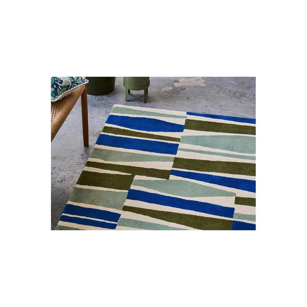 Scion Saku Olive Designer Rug featuring geometric stripe pattern in navy blue, olive, sage and cream on beige background, hand-tufted wool