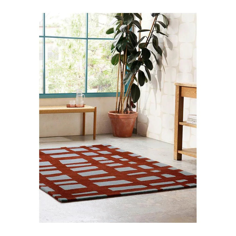 Scion Arlo Brick Designer Rug featuring geometric grid in brick red, pale grey on cream background, hand-tufted wool