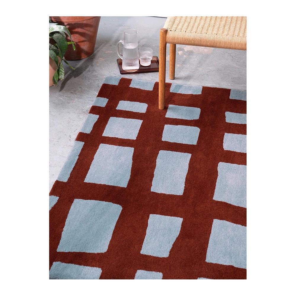 Scion Arlo - Brick Designer Rug featuring geometric grid pattern in brick red and pale blue on light grey background, hand-tufted wool