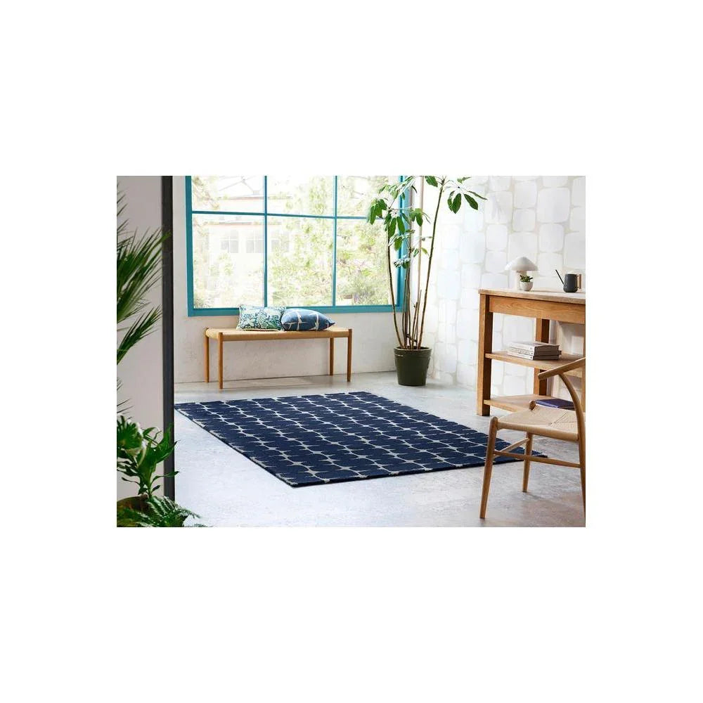 Scion Little Lohko Indigo Designer Rug featuring geometric grid pattern in navy on light grey floor, woven rug