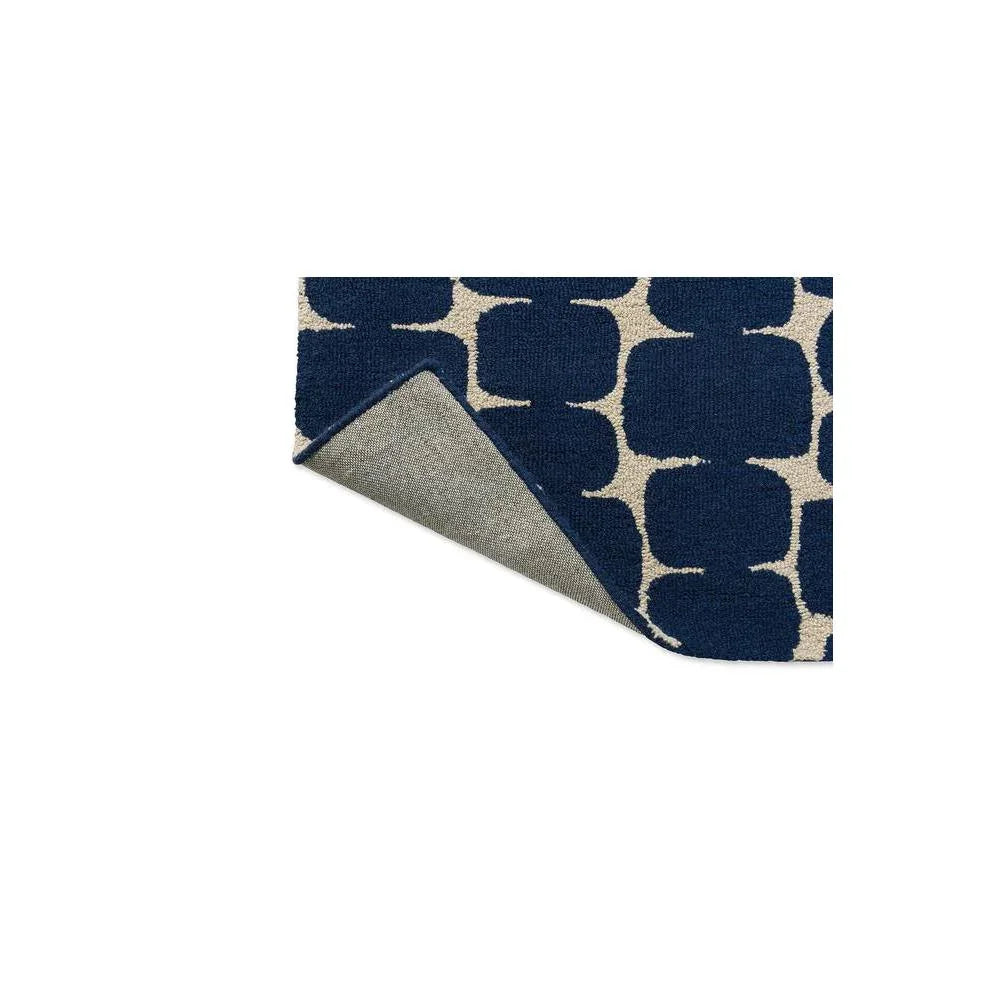 Scion Little Lohko - Indigo Designer Rug featuring geometric trellis pattern in navy blue and cream on light beige background, hand-tufted wool