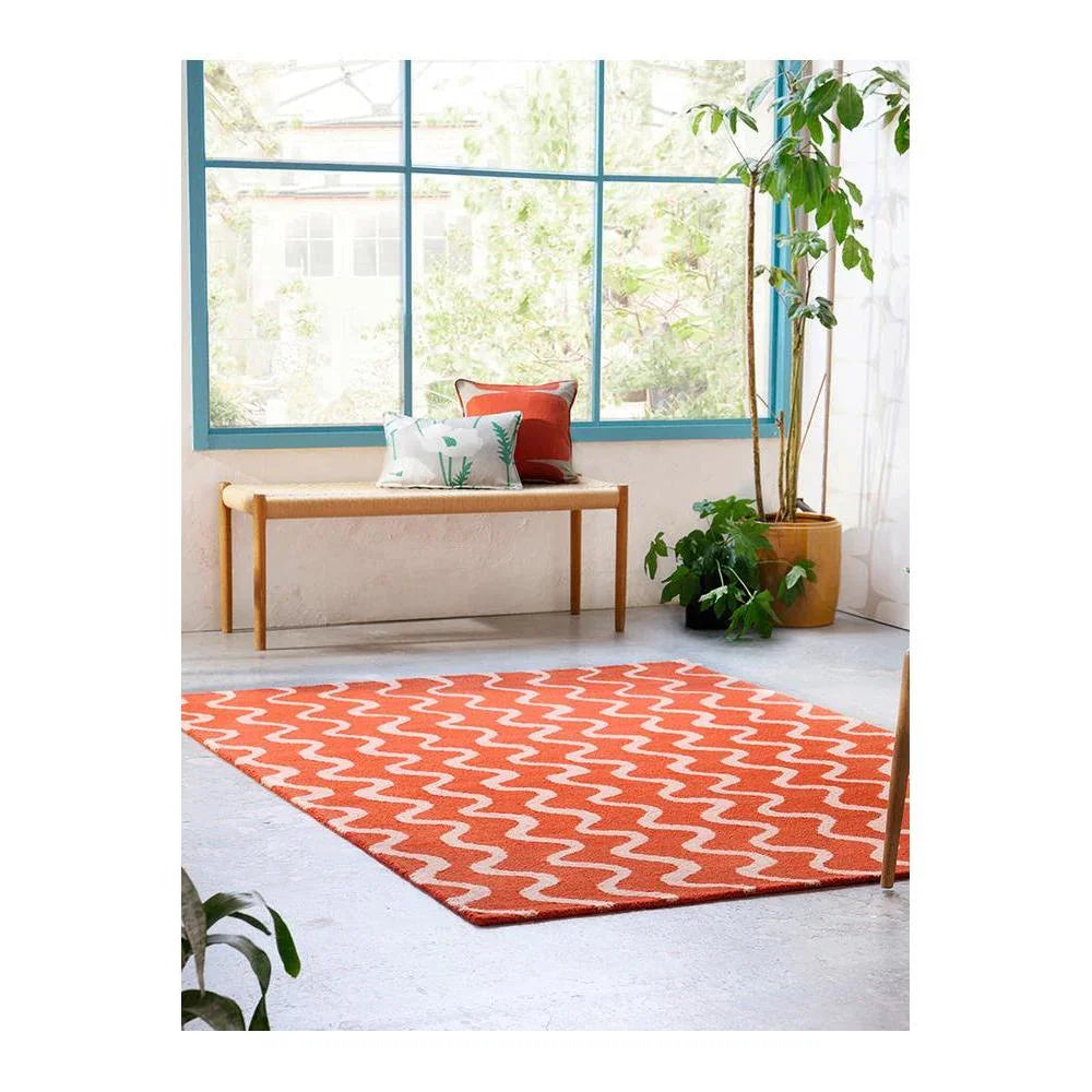 Scion Ribbon - Coral Designer Rug featuring zigzag pattern in coral and white on light grey background, hand-tufted wool