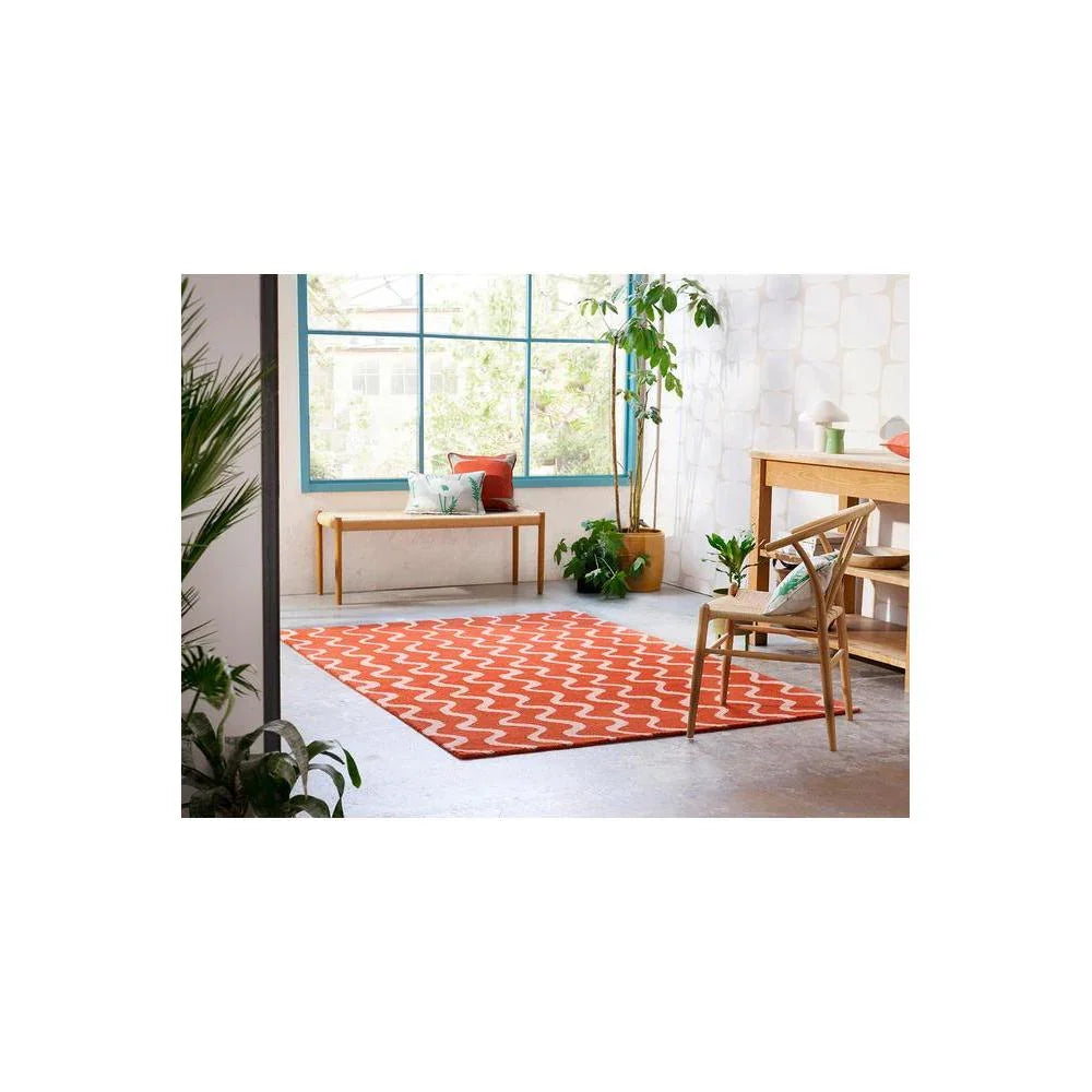Scion Ribbon Coral Designer Rug featuring zigzag pattern in coral and white on light grey floor, power-loomed polyester