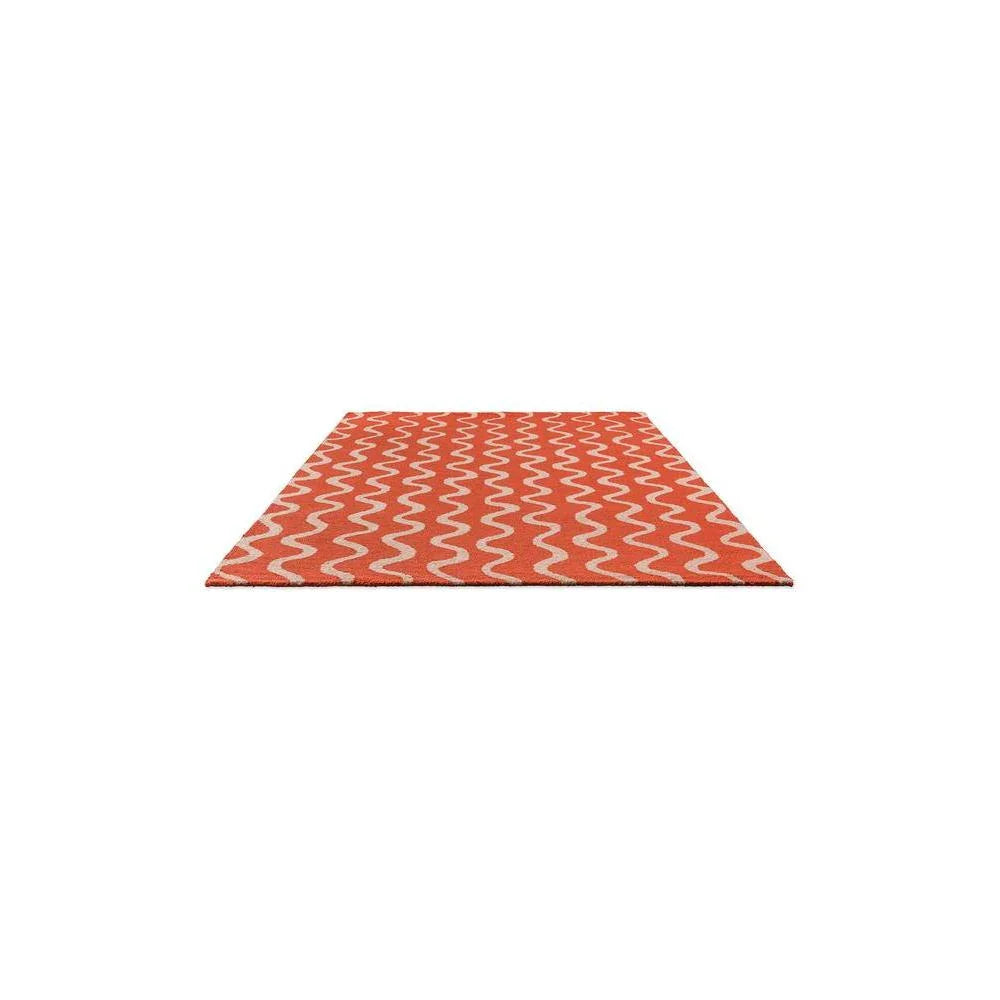 Scion Ribbon Coral Designer Rug featuring wavy ribbon pattern in coral and ivory on cream background, hand-tufted wool