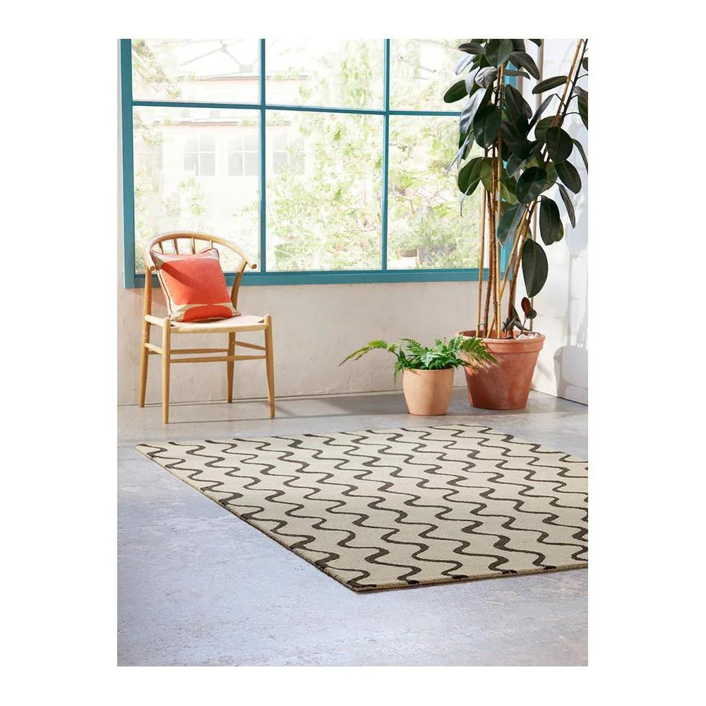 Scion Ribbon Charcoal Designer Rug featuring wavy ribbon pattern in charcoal on cream background, machine-made wool blend