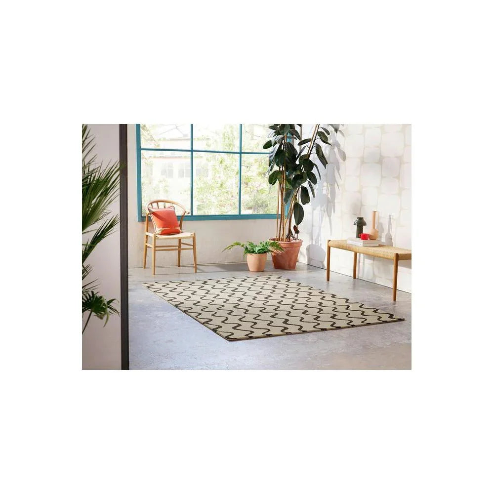 Scion Ribbon Charcoal Designer Rug featuring wavy ribbon pattern in charcoal black on ivory background, machine-woven wool