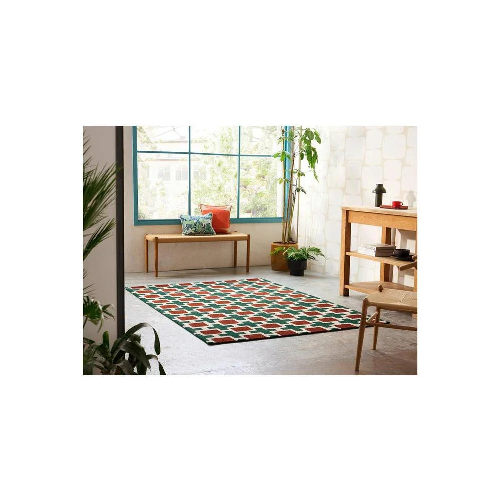 Scion Hatch - Rust Rug featuring geometric hatch pattern in emerald green, rust and cream on pale background, machine-loomed wool