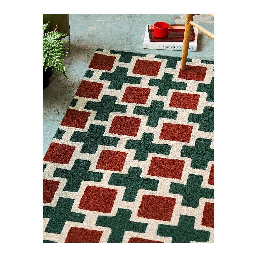 Scion Hatch - Rust Designer Rug featuring geometric lattice in dark green and rust red on cream background, machine-made polyester