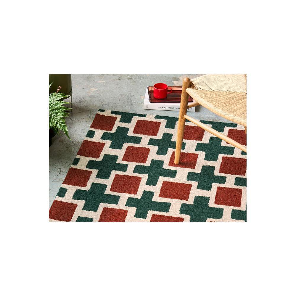 Scion Hatch - Rust Designer Rug featuring geometric cross motif in rust red, forest green on cream background, hand-tufted wool