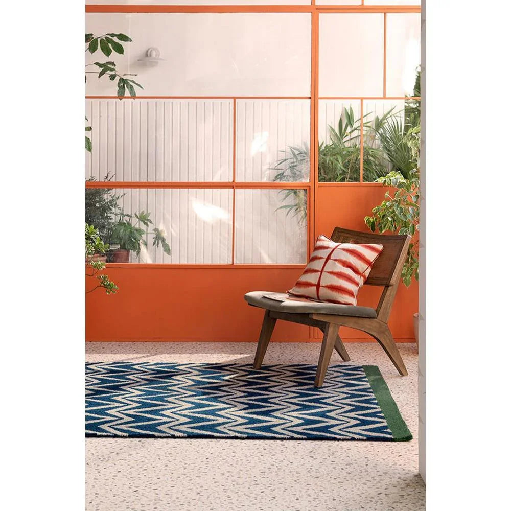 Scion Dhurrie Blue Designer Outdoor Rug featuring navy and cream zigzag chevron on orange patio backdrop, flatwoven cotton