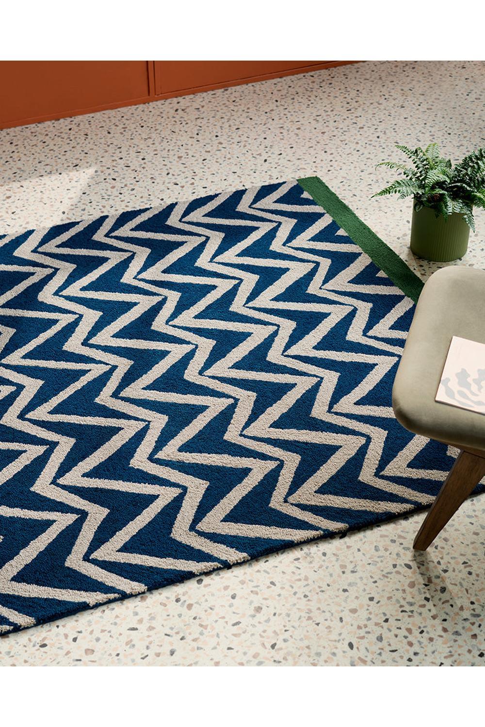 Scion Dhurrie Blue Designer Outdoor Rug featuring navy chevron zigzag in beige on light terrazzo floor, flatweave polypropylene