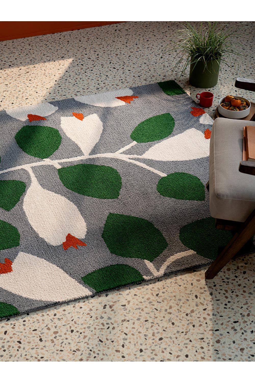 Scion Rosehip Blue Designer Outdoor Rug featuring botanical leaf pattern in emerald green, white and orange on grey-blue background, outdoor rug