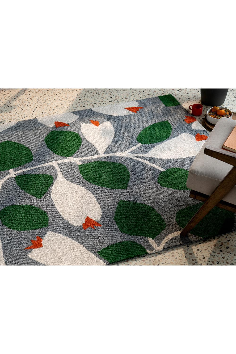 Scion Rosehip Blue outdoor rug featuring botanical leaf pattern in grey-blue, emerald green and white on grey background, machine-made polypropylene