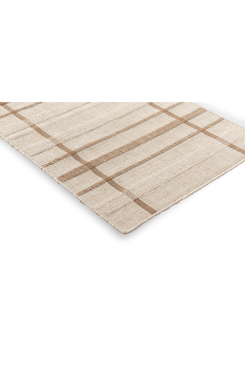 Brink & Campman Zona Sesame Line Runner featuring plaid pattern in beige, taupe & tan on sand background, flat-weave outdoor polypropylene