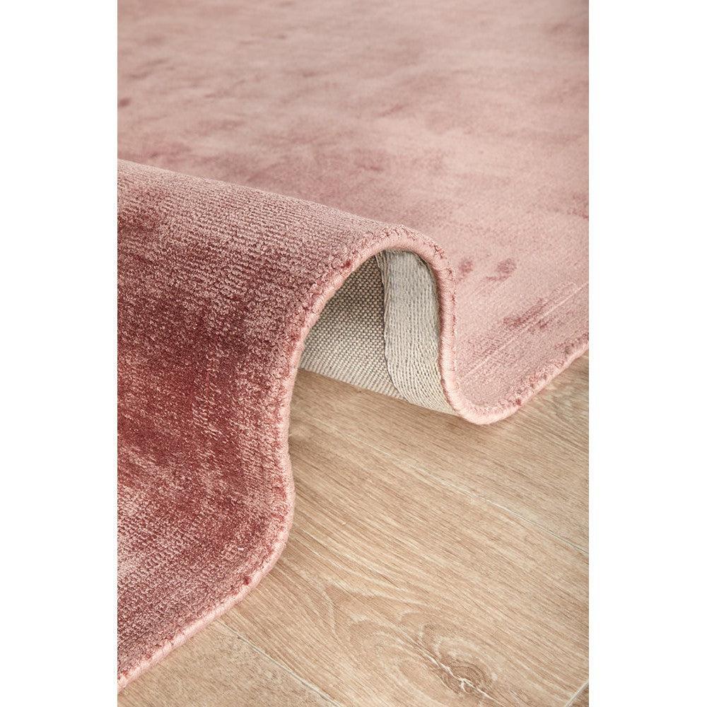 Joy Blush Rug from Rug Culture Bliss Collection featuring a modern design in blush pink with cream backing on beige floor, hand-tufted wool