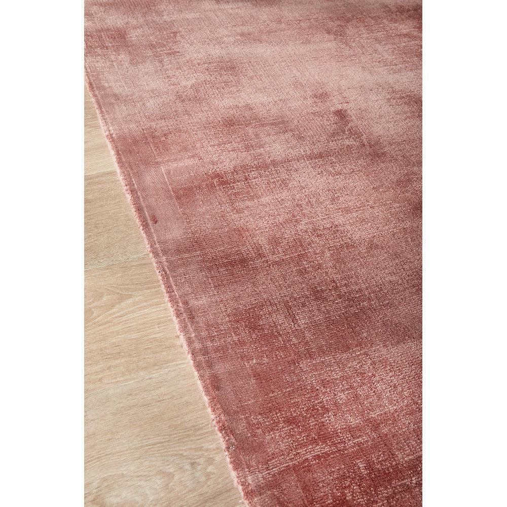 Joy Blush Rug featuring modern distressed pattern in blush pink, rose and dusty pink on light wood floor, hand-tufted wool