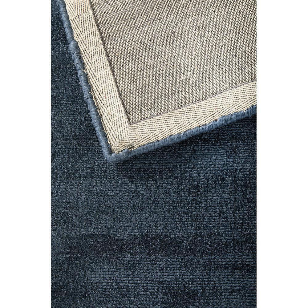 Joy Denim Rug featuring bordered solid denim blue with beige trim on cream background, hand-tufted wool