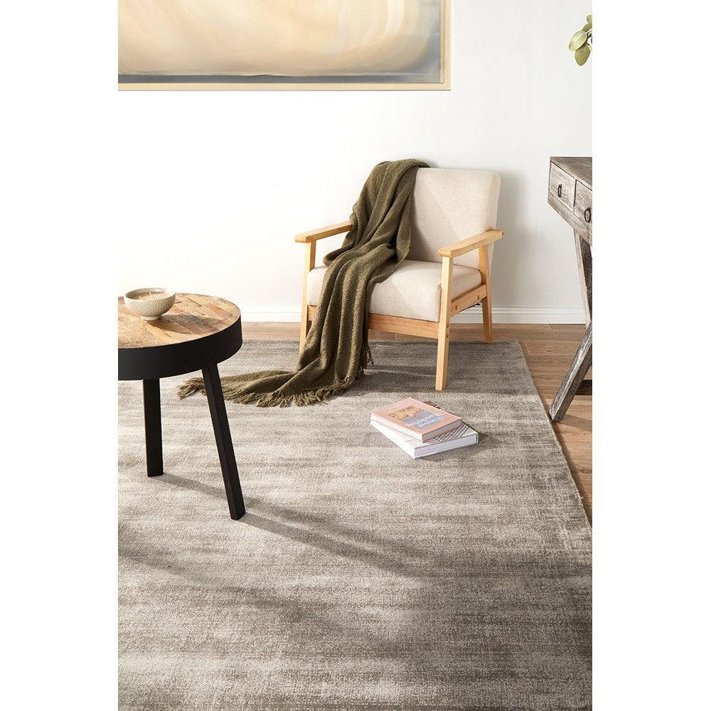 Joy Grey Rug from Bliss Collection featuring soft grey gradient on a light beige background in a minimal living room.