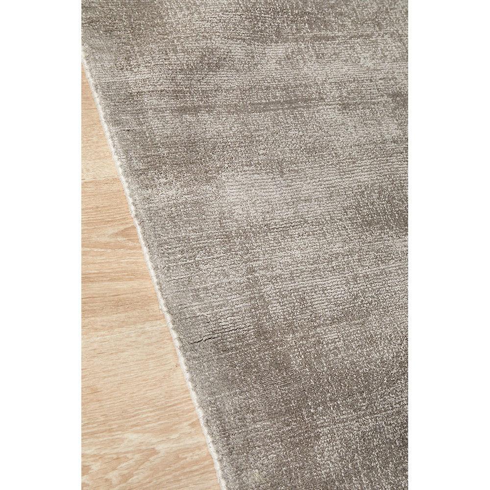 Joy Grey Rug featuring gradient textured pattern in charcoal grey, ash grey, taupe on light beige floor, machine-made polyester blend