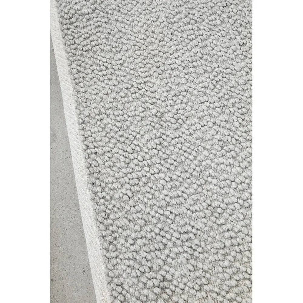 Boucle Grey Rug featuring boucle texture in light grey on soft grey background, hand-tufted wool