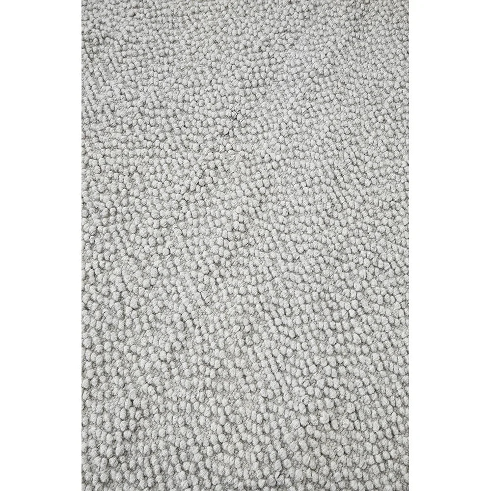 Boucle Grey Rug featuring boucle texture in light grey on soft grey background, hand-tufted wool