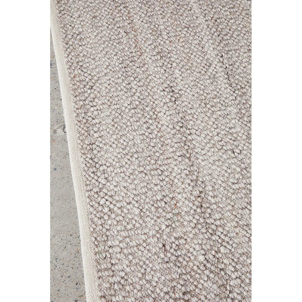 Boucle Natural Rug featuring boucle texture in cream-beige on light ivory background, boucle weave rug, wool