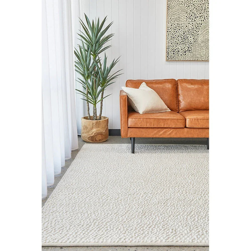 Boucle White Rug featuring boucle texture in ivory and cream on pale beige floor, machine-made wool