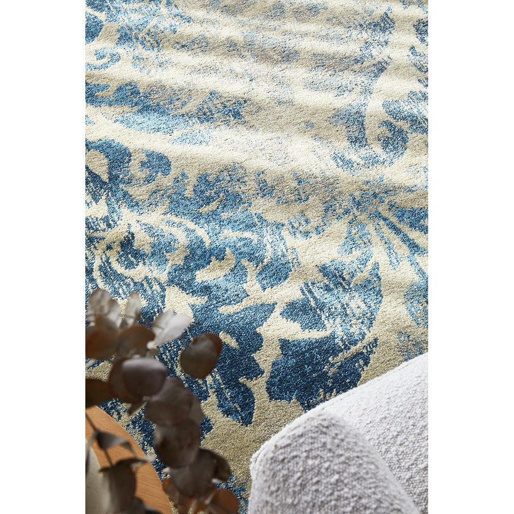 Calypso Bone Rug featuring abstract floral pattern in blue, beige and cream on bone background, hand-tufted wool