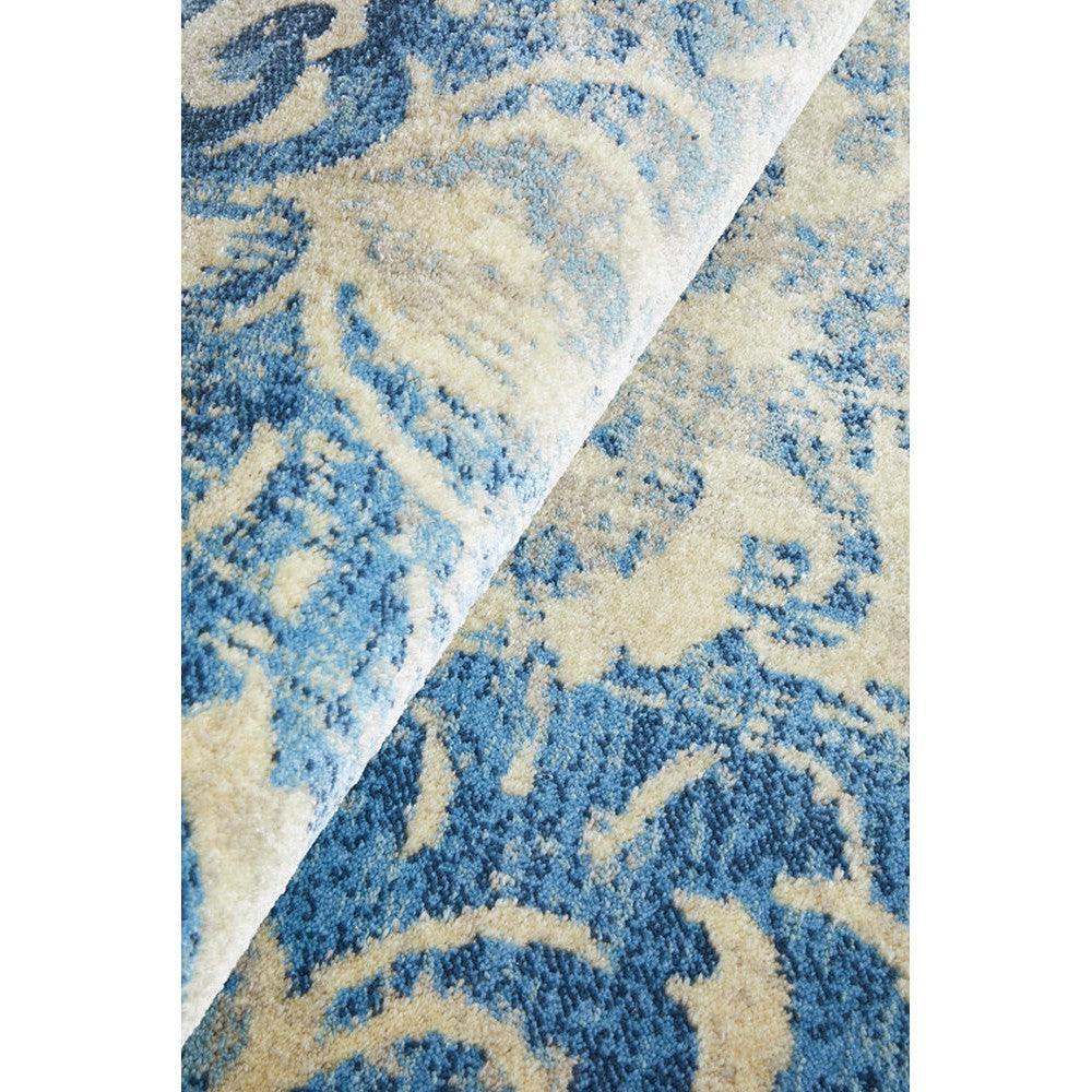 Calypso Bone Rug featuring abstract floral pattern in navy blue, sky blue and cream on ivory background, hand-tufted wool