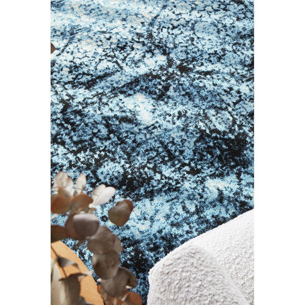 Calypso Navy Rug featuring abstract distressed pattern in navy, royal blue and sky blue on cream background, hand-tufted wool