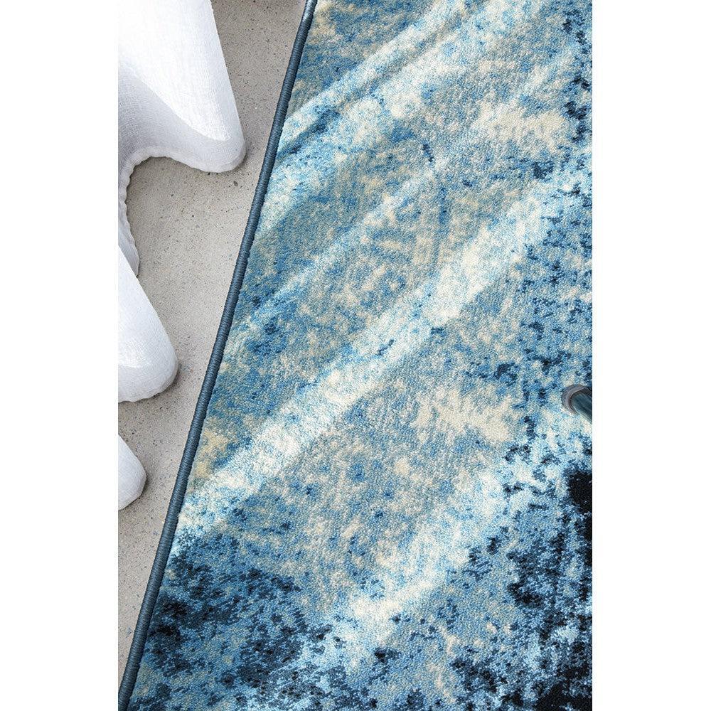 Calypso Navy Rug featuring abstract distressed pattern in navy, sky blue and cream on cream background, machine-made polyester