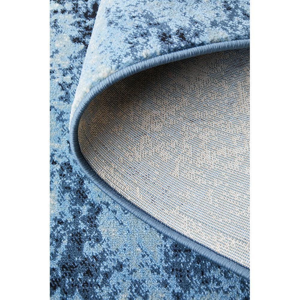 Calypso Navy Rug featuring abstract distressed pattern in navy blue, royal blue, sky blue, light blue on medium blue background, power-loomed polyester