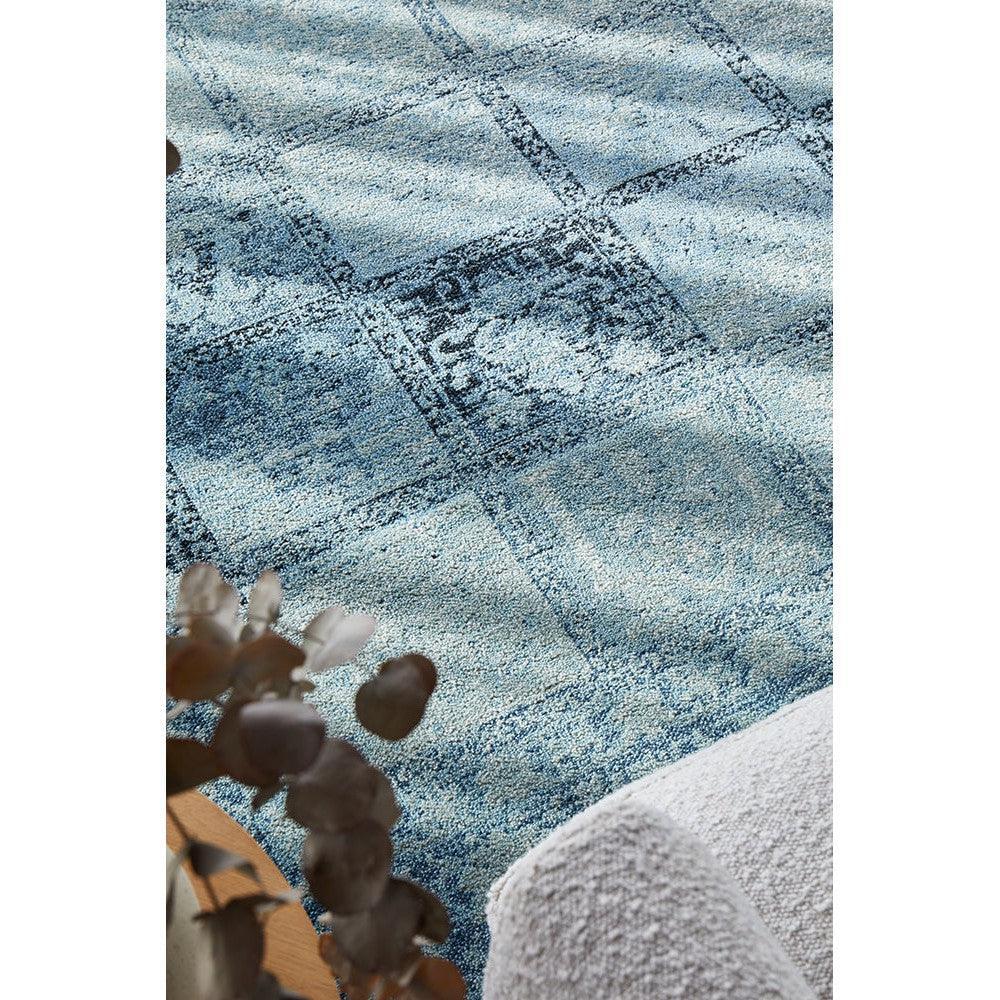 Calypso Blue Rug featuring distressed abstract grid pattern in navy blue, powder blue, teal on light blue background, hand-tufted wool