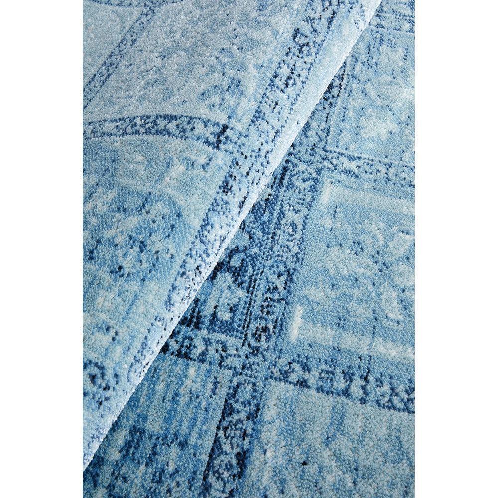 Calypso Blue Rug featuring distressed geometric pattern in navy blue, sky blue and aqua on pale blue background, hand-tufted wool