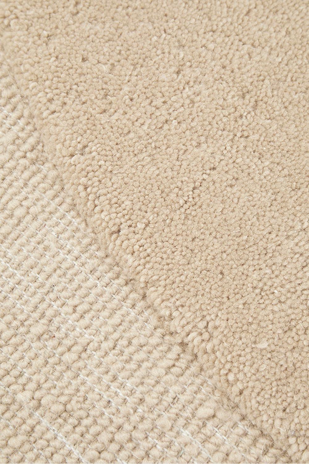 Cleo Beige Rug featuring subtle curved boucle pattern in cream-beige on warm beige background, machine-made wool