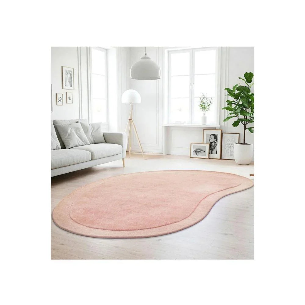 Cleo Blush Rug featuring soft curved shape in blush pink, dusty pink and peach on cream background, hand-tufted wool