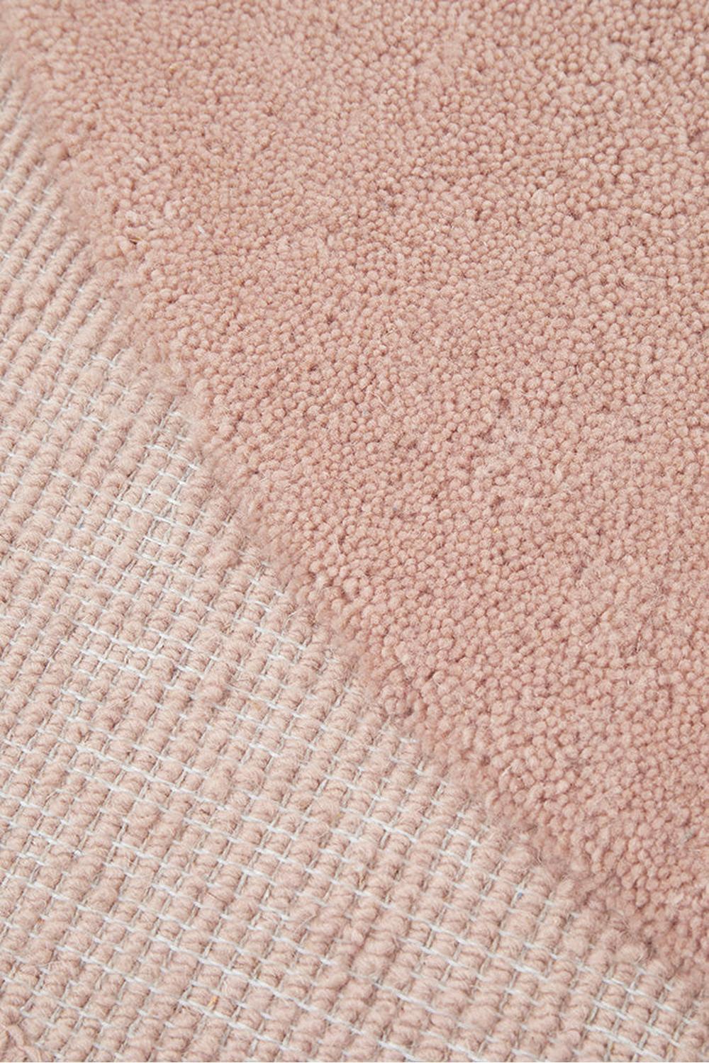 Cleo Blush Rug featuring shaggy solid pattern in blush pink on pale beige background, hand-tufted wool