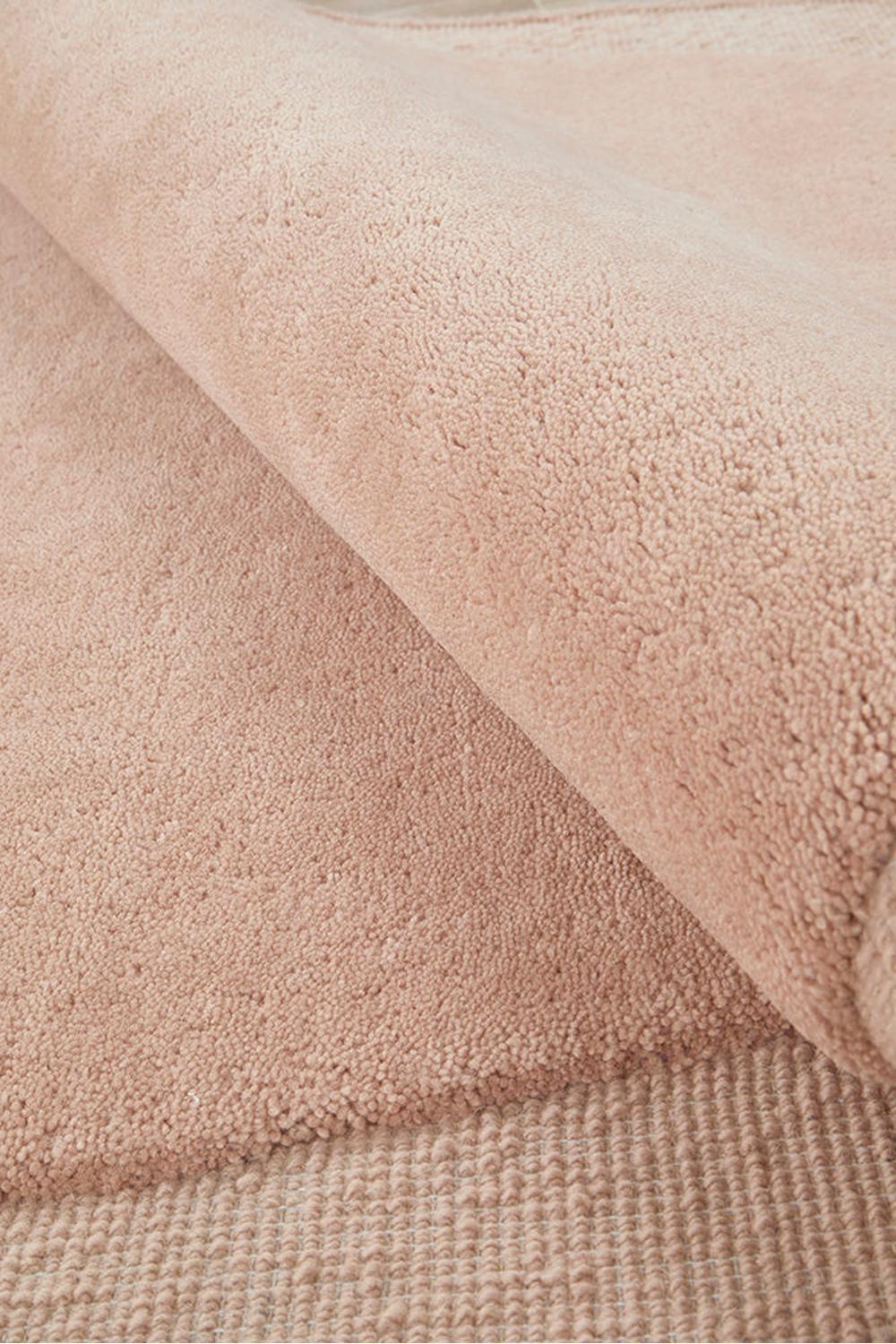 Cleo Blush Rug featuring plush shag pattern in blush pink, rose, champagne on pale pink background, hand-tufted wool