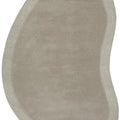 Cleo Latte Rug featuring a soft curved oval design in latte beige and sand tones on pale beige background, hand-tufted wool