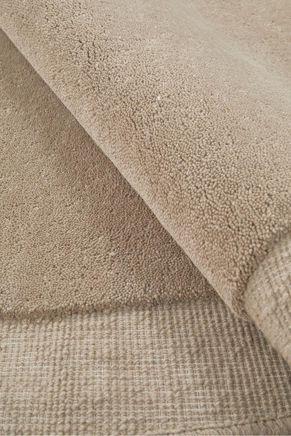 Cleo Latte Rug featuring soft plush texture in beige latte tones with a woven border on a light beige background, machine-made