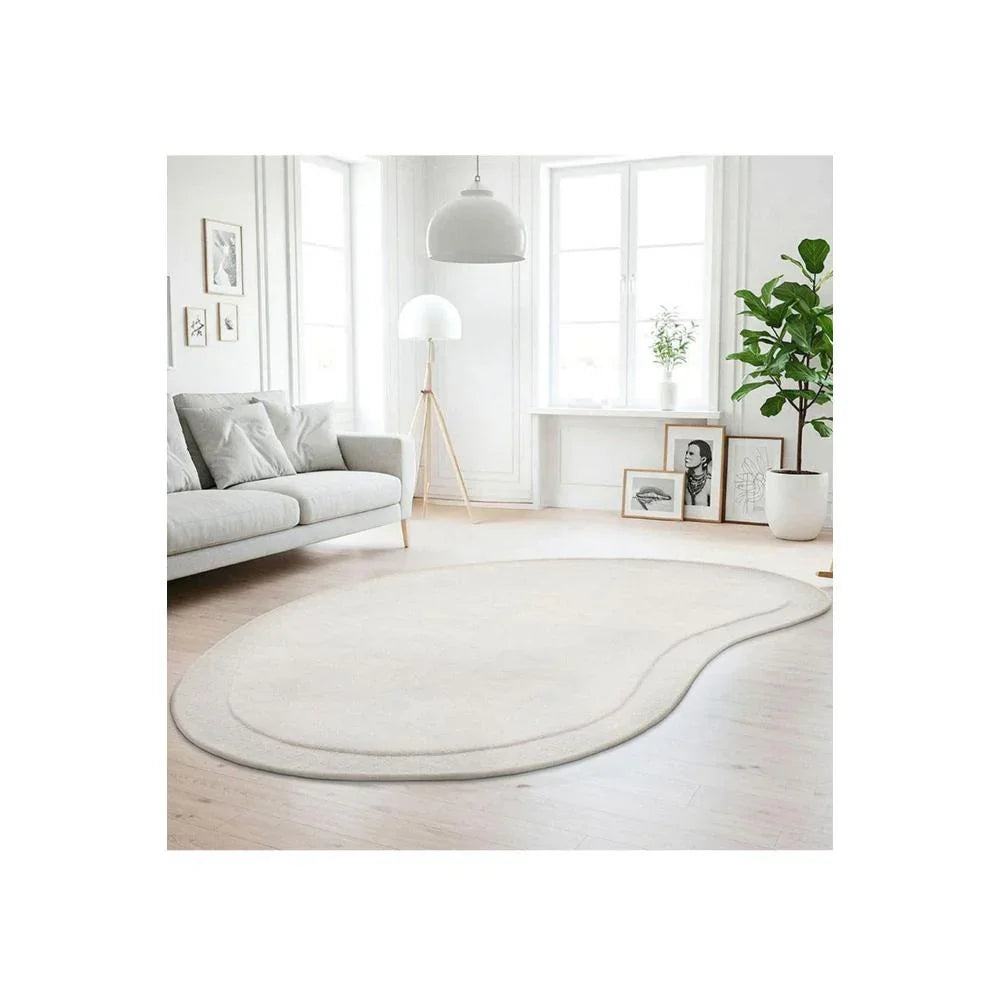 Cleo Milk Rug featuring soft curved pattern in cream, ivory and beige on white background, machine-woven wool