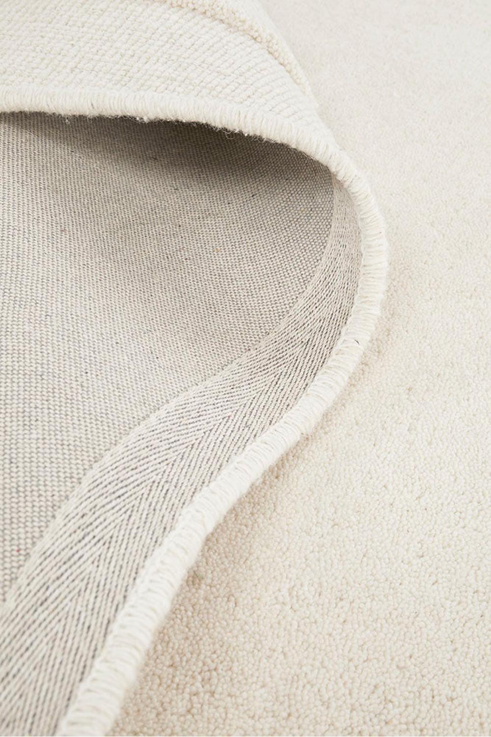 Cleo Milk Rug featuring soft textured solid cream on ivory background, hand-tufted wool