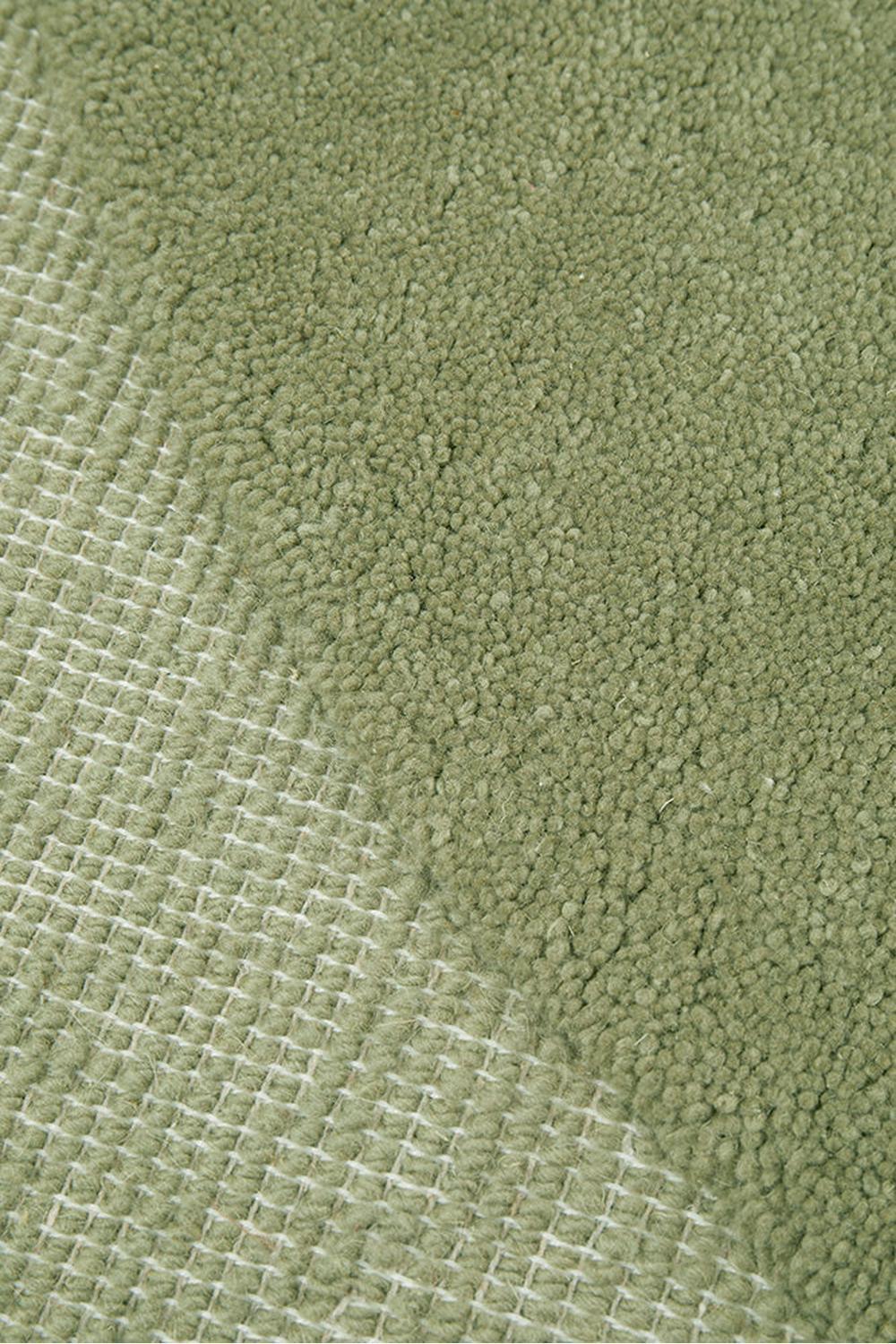 Cleo Moss Rug featuring plush tufted texture with a subtle grid pattern in moss green on light sage background, hand-tufted wool